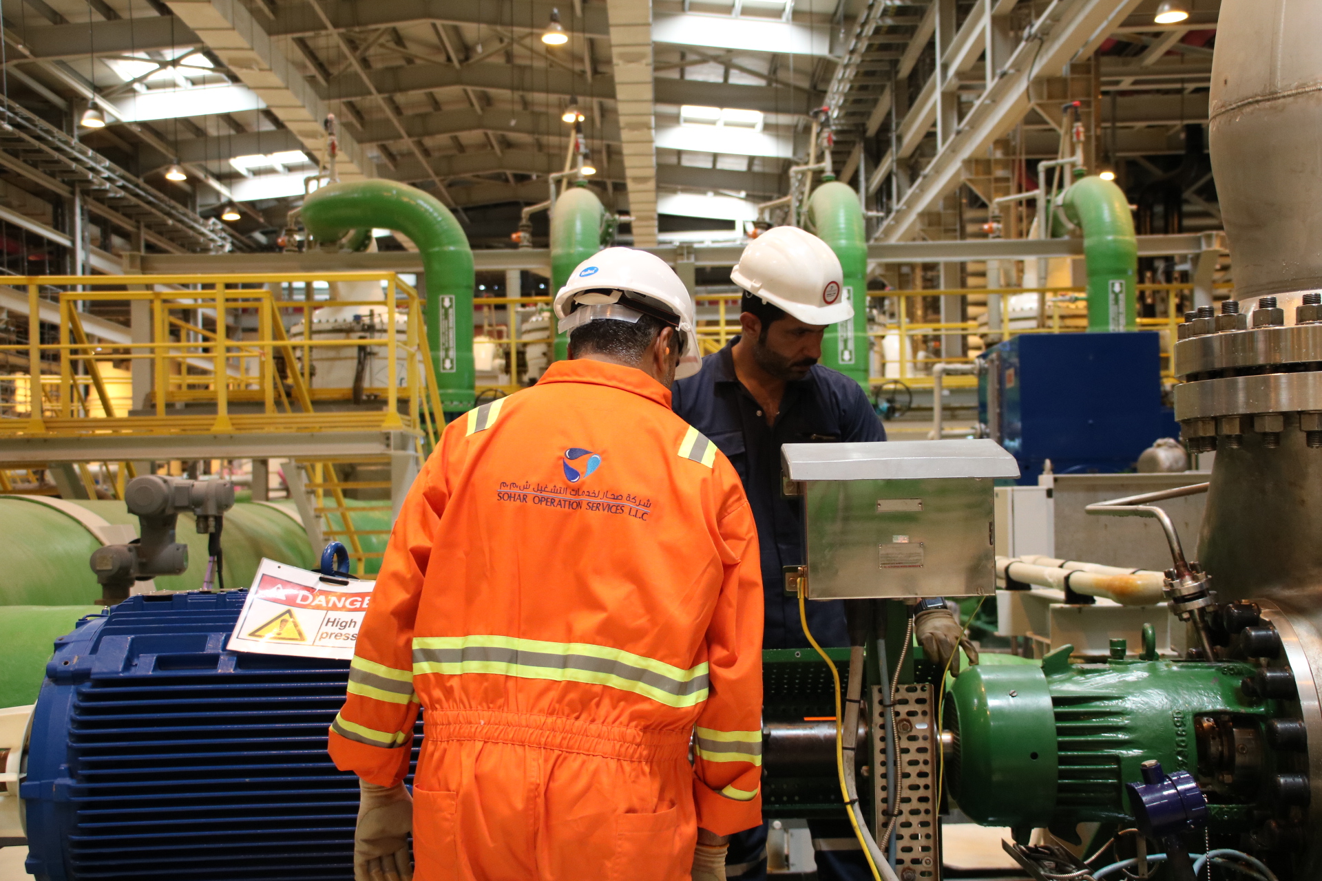 Engineers in SOS safety suits at pump station